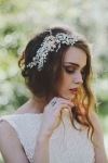 Exclusive to Bride La Boheme this gorgeous head comb is made with multiple ivory pearls wired with silver and gold floral findings with numerous sparkly crystals and leaves . Its attached onto a gold comb